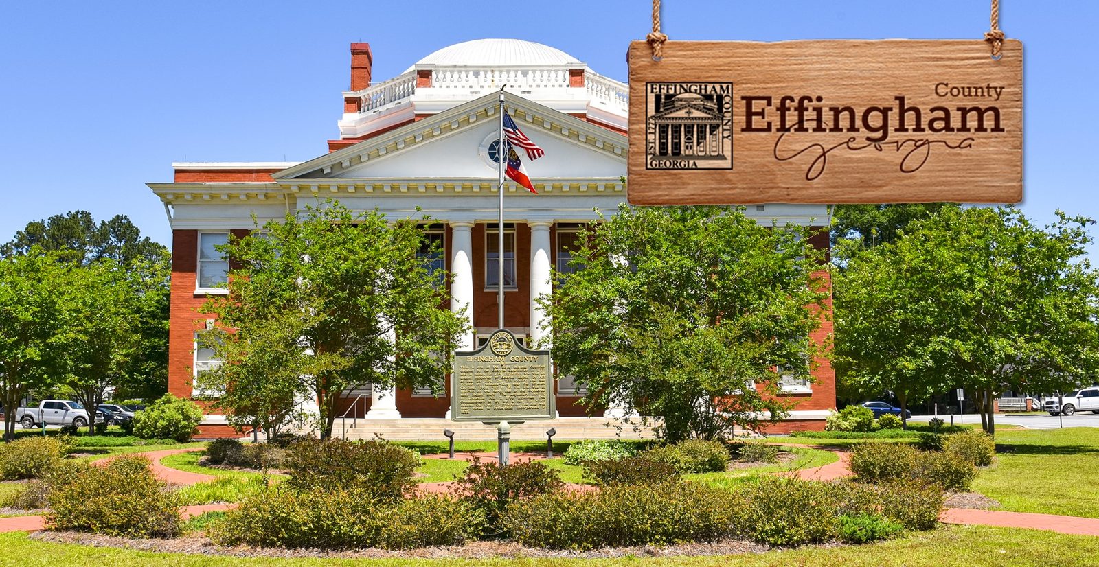 Domed historic courthouse behind landscaped grounds, with an Effingham County sign graphic