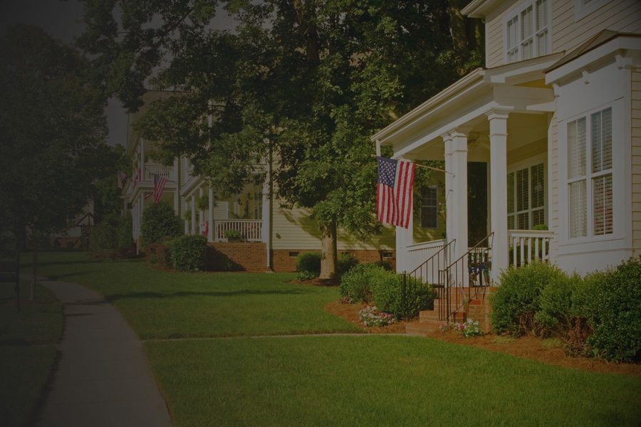 Front porch of a house with a flag