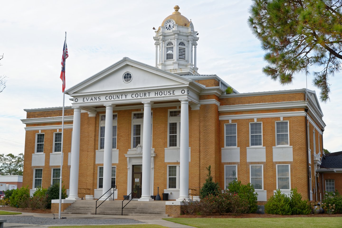 Evans County Courthouse, a yellow-brick building with white columns and a flagpole in Evans County, Georgia