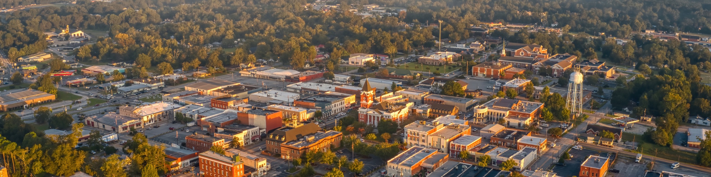Aerial view of downtown Statesboro, Georgia, with brick commercial buildings and tree-lined streets